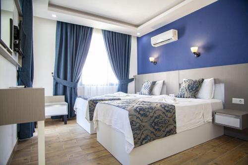Postel nebo postele na pokoji v ubytování Demyra Boutique Hotel