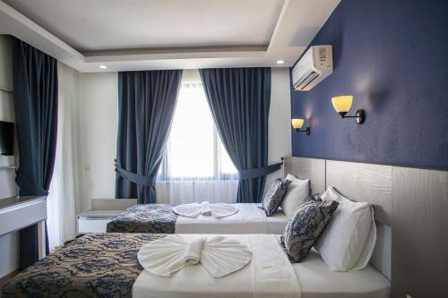Postel nebo postele na pokoji v ubytování Demyra Boutique Hotel