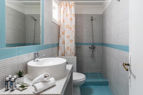 a bathroom with a sink and a toilet at PSARIANOS BEACHFRONT APARTMENTS in Panormos Skopelos