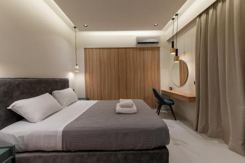 a bedroom with a bed and a chair and a mirror at Sul Mare in Kalamata