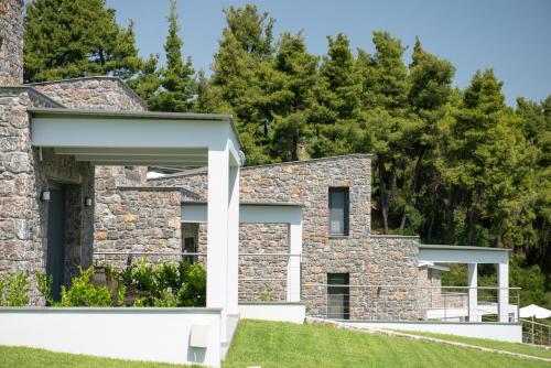 a stone house with a stone facade at Terra Olivia Luxury Villas and Suites in Paliouri