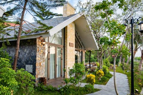 a brick house with a window and a porch at Bai Dinh Riverside Resort & Spa in Ninh Binh