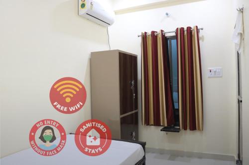 a hospital room with a bed and signs on the wall at Hotel Saraswati Palace in Varanasi