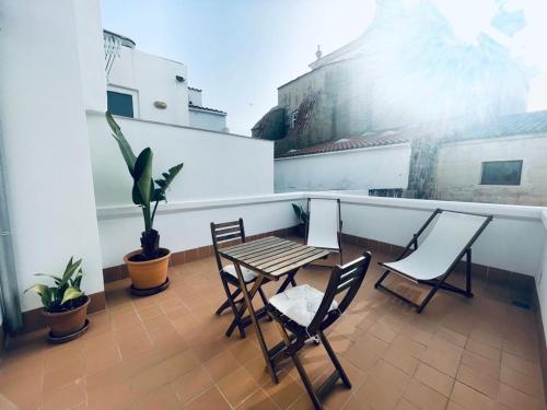a patio with a table and chairs on a balcony at Hotel Casa Miranda - Adults Only in Mahón