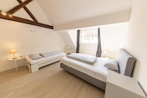 a bedroom with two beds and a window at Braviscasa - Ferienresidenz Kenzingen Europa Park in Kenzingen