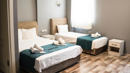 a bedroom with two beds with towels on them at Puffin Boutique - Istanbul in Istanbul