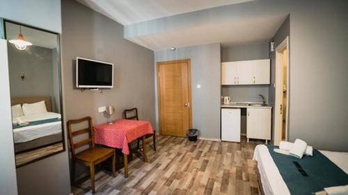a small hotel room with a table and a kitchen at Puffin Boutique - Istanbul in Istanbul