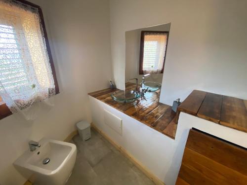 a bathroom with a sink and a mirror at Belvedere in San Teodoro