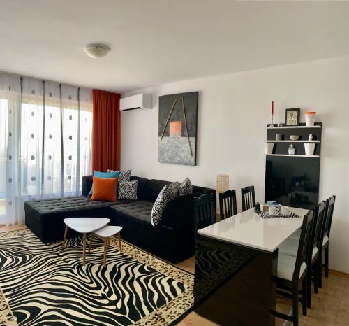 a living room with a couch and a table at Byala Solita Apartament in Byala