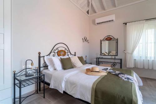 a bedroom with a bed with a hat on it at Muse Clio in Halki