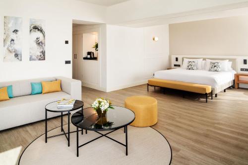 a hotel room with a bed and a couch at Arrecife Gran Hotel & Spa in Arrecife