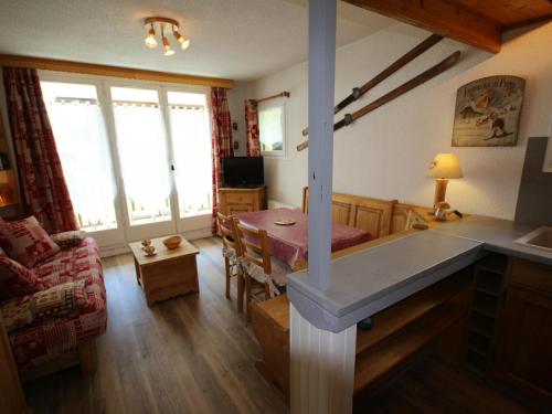 a kitchen and living room with a table and a dining room at Appartement Les Saisies, 2 pièces, 5 personnes - FR-1-293-120 in Les Saisies