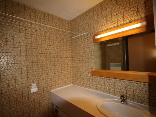 a bathroom with a sink and a mirror at Studio Les Saisies, 1 pièce, 4 personnes - FR-1-293-173 in Les Saisies