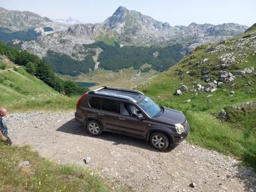 a suv parked on the side of a mountain at Holiday bungalows Pajkovir in Kolašin