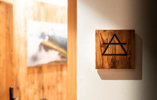 a lightswitch on a wall with a sign on it at Chalet Insignis in Santa Cristina in Val Gardena