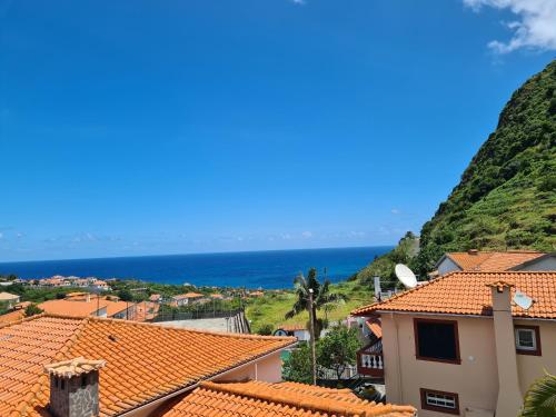 a view of the ocean from the roofs of a town at Scenic Comfort in Ponta Delgada
