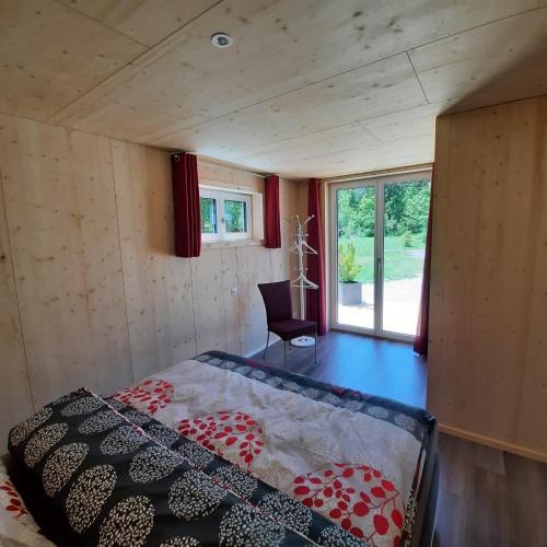 a room with a bed in a tiny house at Aktien 11 / A=obere Wohnung / B=untere Wohnung in Sils im Domleschg