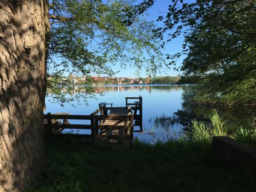 a view of a lake with a wooden dock at Ferienwohnung Seeblick Ratzeburg in Ratzeburg