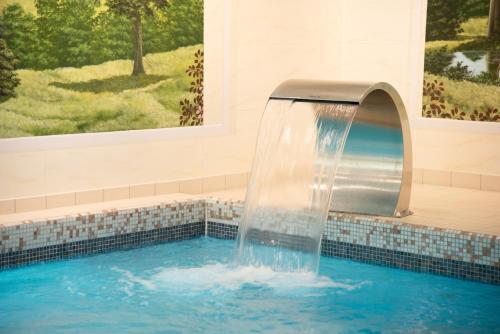 a water fountain in a swimming pool at Landhaus Wacker in Wenden