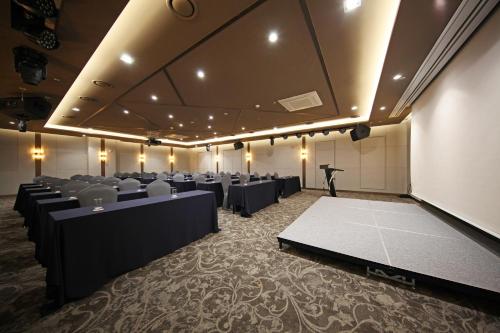 a conference room with tables and chairs and a podium at Layers Hotel Busan Hadan in Busan