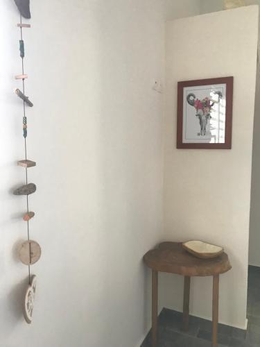a room with a table and a picture on the wall at LES ALOÈS By CREYOL ANIMAL in Grand-Bourg