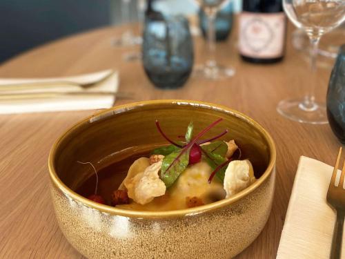 a bowl of food sitting on top of a table at Mercure Saint Omer Centre Gare in Saint-Omer