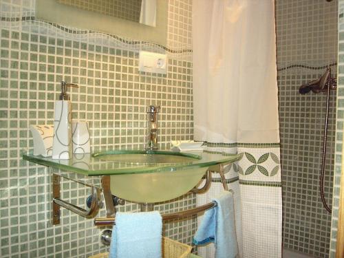 a bathroom with a glass sink and a shower at LA LAGUNA in Vejer de la Frontera
