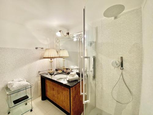 a bathroom with a sink and a shower at Case Natoli - Residenze d'Epoca in Palermo