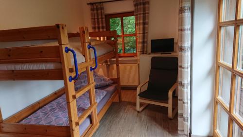 a room with two bunk beds and a desk at Sonnenhügel in Arrach