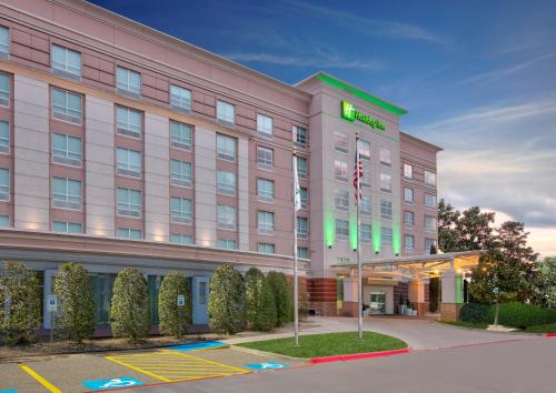 a hotel with a sign on the front of it at Holiday Inn Dallas - Fort Worth Airport South by IHG in Euless