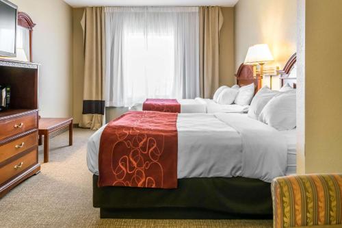 a hotel room with a large bed and a window at Comfort Suites in Owensboro