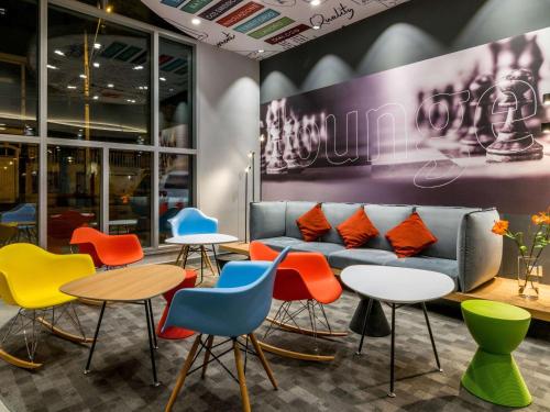 a room with tables and chairs and a couch at ibis Iquique in Iquique