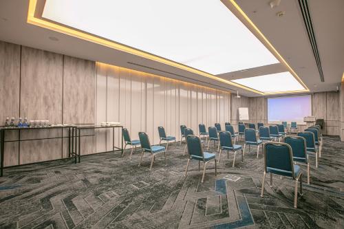 a conference room with chairs and a podium with a screen at InterContinental Baku by IHG in Baku
