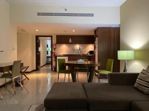 a living room with a couch and a table at Phoenix Plaza Hotel Apartments in Abu Dhabi