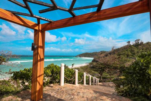 a view of the beach from a wooden pergola at Belmont Hotel Boracay near Newcoast Beach in Boracay