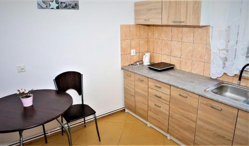 a small kitchen with a table and a sink at Pokoje Gościnne 2 in Gdańsk