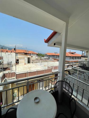 a balcony with a table and a view of a building at Afrodite Beach in Nei Poroi