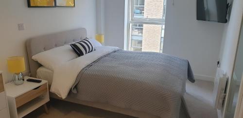 a bedroom with a bed and a window at Quay Apartments Exchange Quay in Manchester