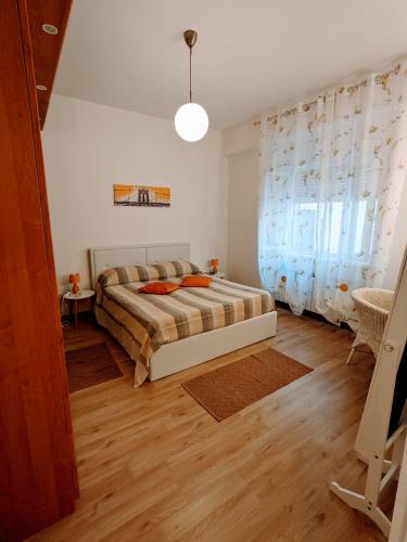 ein Schlafzimmer mit einem Bett und einem großen Fenster in der Unterkunft Casa Vacanza Due Elle - Casa Margherita in Triest