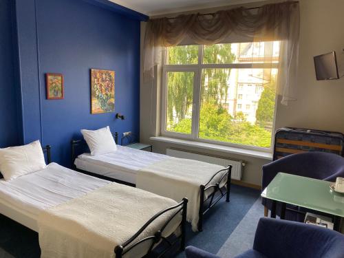 a hospital room with two beds and a window at Hotel Kert FREE PARKING in Rīga