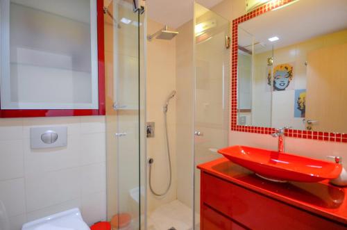 a bathroom with a red sink and a shower at YalaRent Eucalyptus 2BR & Balcony APT in Eilat