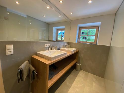 a bathroom with two sinks and a mirror at Gasthaus Sulzfluh in Schruns