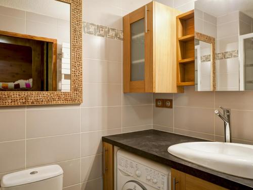 a bathroom with a sink and a washing machine at Studio Brides-les-Bains, 1 pièce, 4 personnes - FR-1-512-220 in Brides-les-Bains
