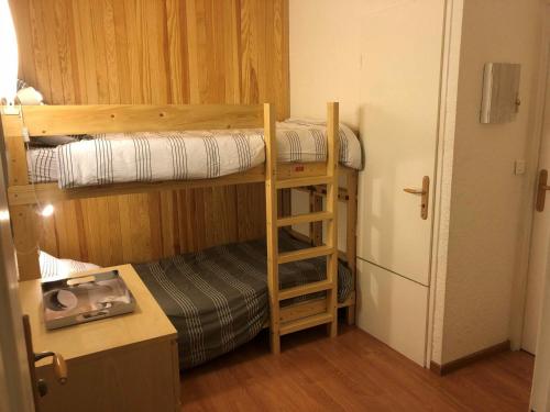 a room with two bunk beds and a refrigerator at Studio Les Deux Alpes, 1 pièce, 4 personnes - FR-1-516-136 in Les Deux Alpes