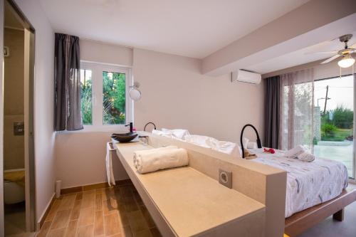 a bedroom with a large bed and a window at Gyra Villas - Seaview Villa Fivos with private pool in Lefkada