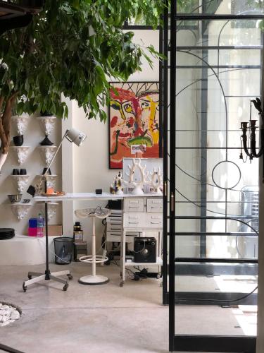 an office with a desk and a table with a lamp at MORO Marrakech Boutique Hôtel in Marrakech