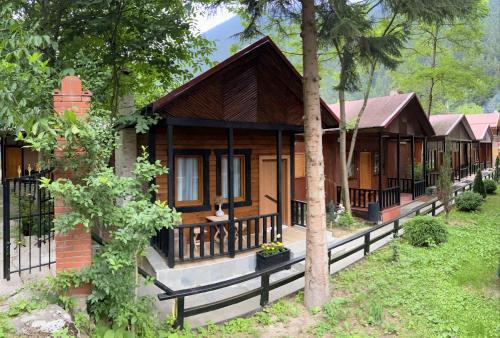 a small house in the middle of a forest at Inanlar Garden Hotel & Bungalow in Uzungol