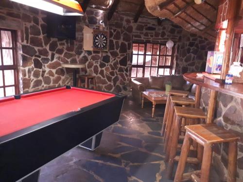 a room with a pool table and a bar at ThabaNkwe Bushveld Inn in Thabazimbi