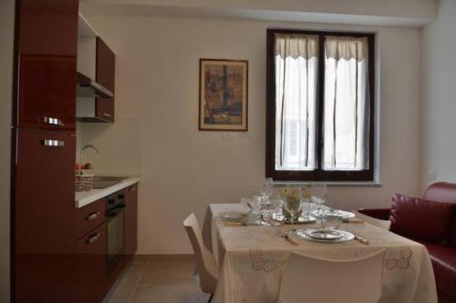 a living room with a table and a kitchen at App. a 30mt dal mare in Pietra Ligure