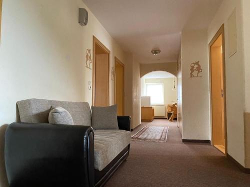 a living room with a couch and a chair at Wertacher Hof in Oy-Mittelberg